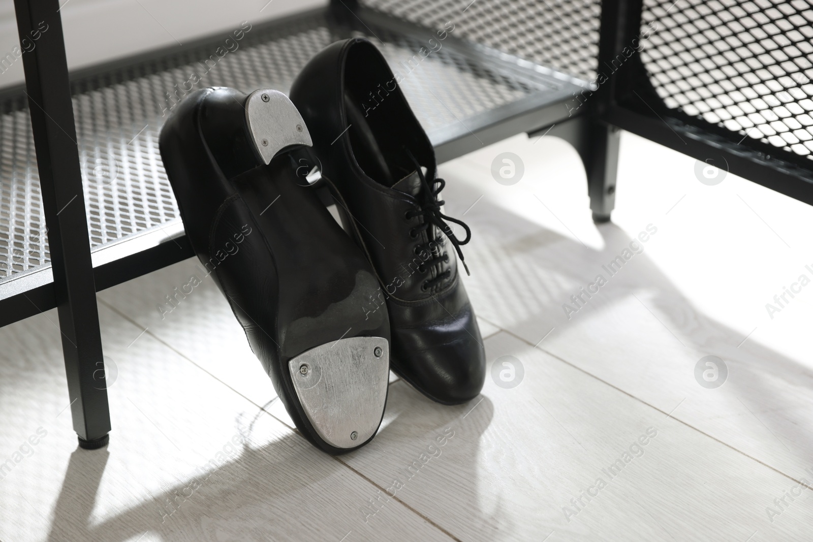 Photo of Pair of shoes for tap dance near shoe storage indoors