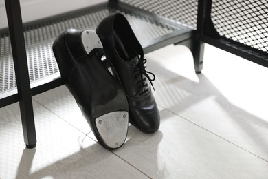 Photo of Pair of shoes for tap dance near shoe storage indoors