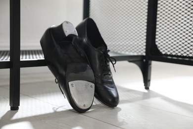 Photo of Pair of shoes for tap dance near shoe storage indoors