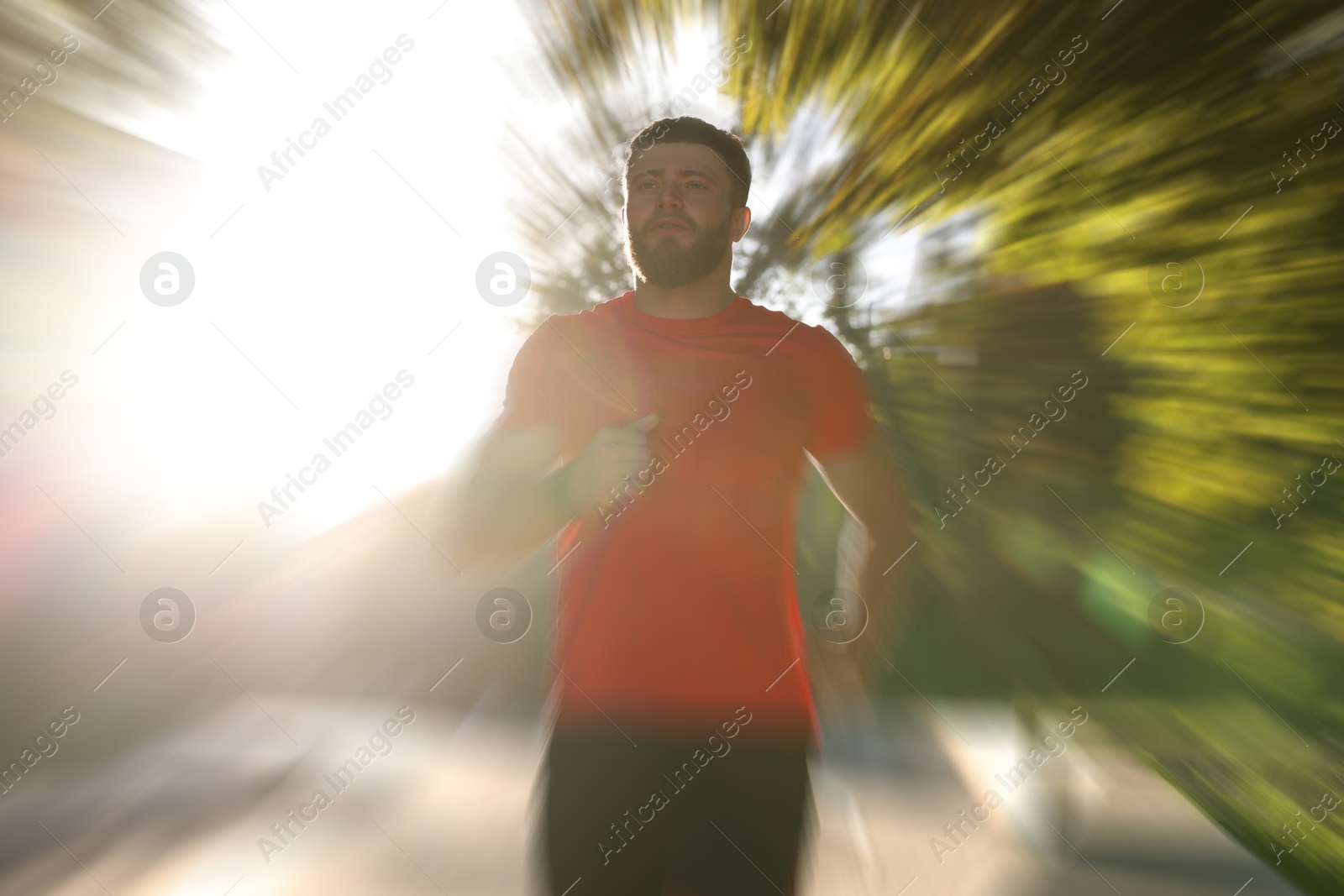 Athletic man running outdoors on sunny day, motion blur effect Image of Athletic man running outdoors on sunny day, motion blur effect