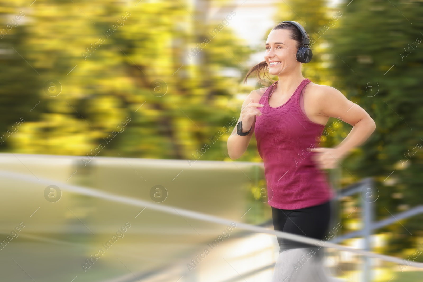 Woman in sportswear running outdoors, motion blur effect Image of Woman in sportswear running outdoors, motion blur effect