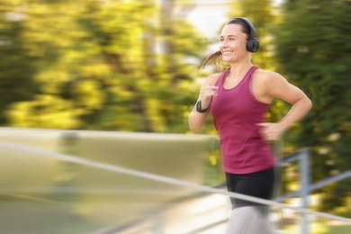 Image of Woman in sportswear running outdoors, motion blur effect