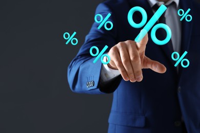 Image of Businessman touching virtual percent sign against dark grey background, closeup