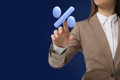 Image of Business woman touching virtual percent sign against dark blue background, closeup