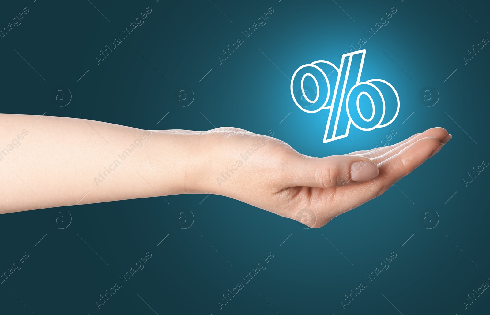 Woman holding virtual percent sign against teal background, closeup Image of Woman holding virtual percent sign against teal background, closeup