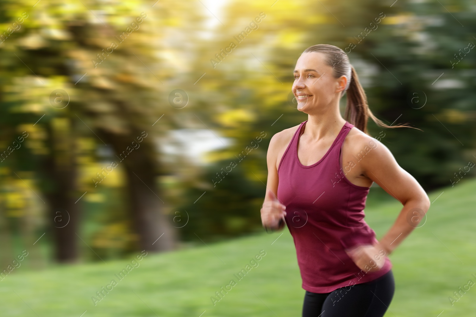 Woman in sportswear running outdoors, motion blur effect Image of Woman in sportswear running outdoors, motion blur effect