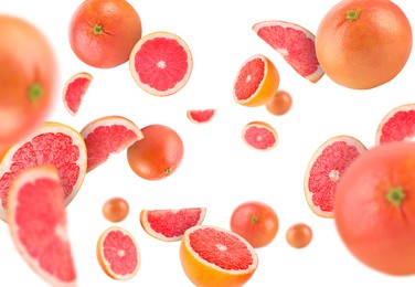 Image of Fresh grapefruits swirling in air against white background