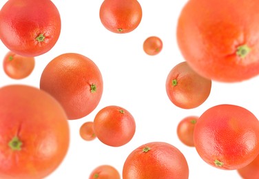 Image of Fresh grapefruits swirling in air against white background
