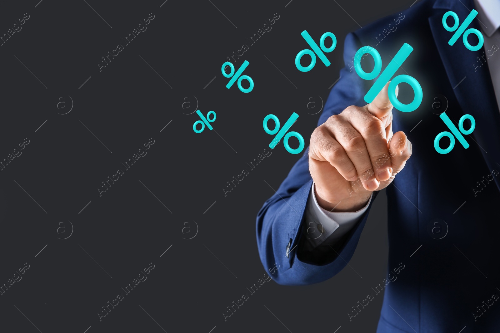 Businessman touching virtual percent sign against dark grey background, closeup Image of Businessman touching virtual percent sign against dark grey background, closeup