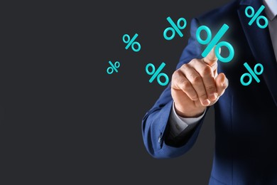 Image of Businessman touching virtual percent sign against dark grey background, closeup