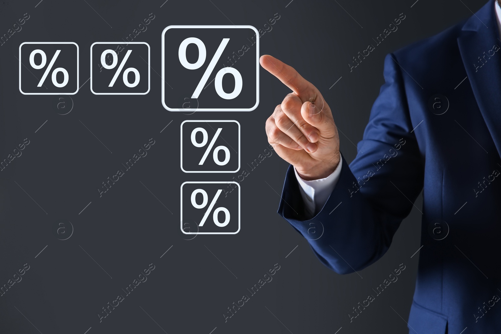 Businessman touching percent sign on virtual screen against dark grey background, closeup Image of Businessman touching percent sign on virtual screen against dark grey background, closeup