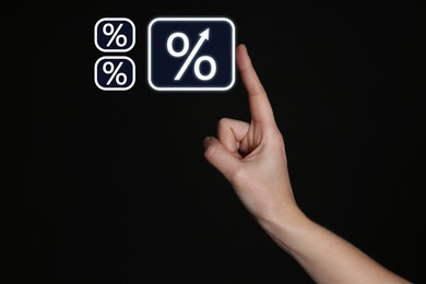 Image of Woman touching virtual percent sign against black background, closeup