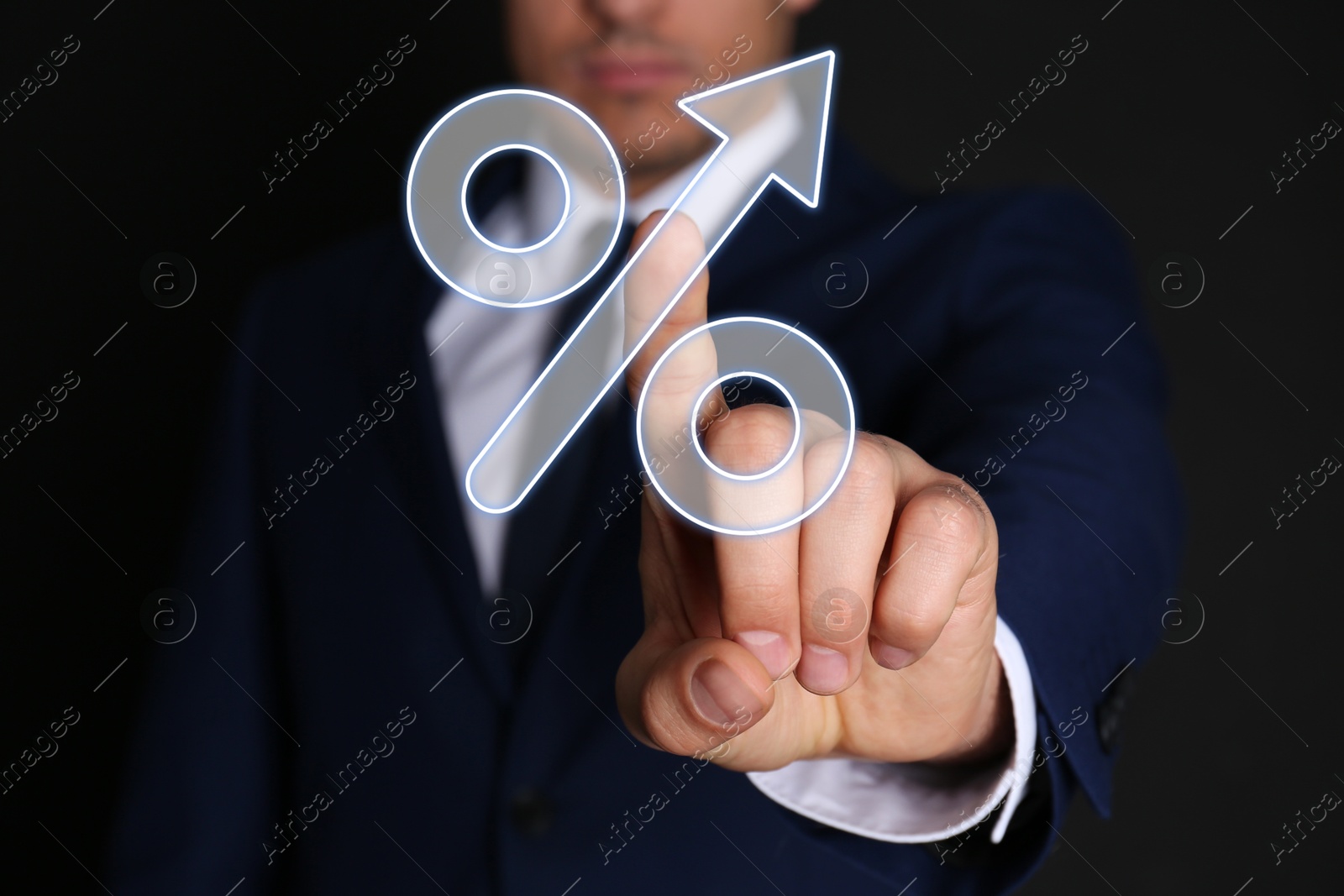 Image of Businessman touching percent sign on virtual screen against black background, closeup