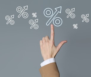 Image of Business woman touching virtual percent sign against grey background, closeup