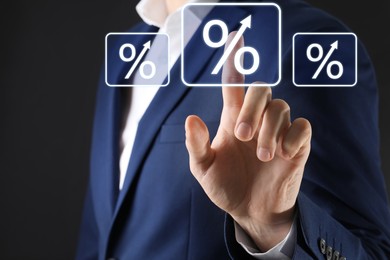 Image of Businessman touching percent sign on virtual screen against black background, closeup