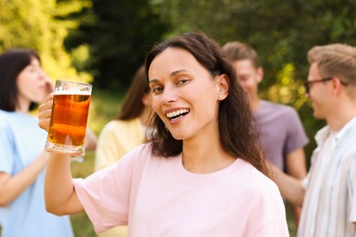 Photo of Group of happy friends having fun and drinking beer outdoors, selective focus