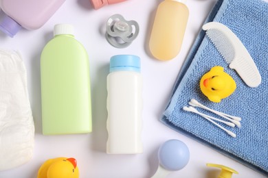 Photo of Baby accessories and cosmetic products on white background, flat lay