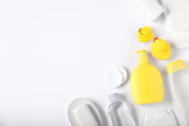 Photo of Baby accessories and cosmetic products on white background, flat lay. Space for text