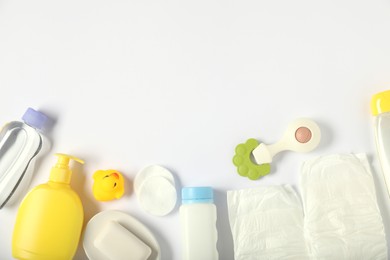 Photo of Baby accessories and cosmetic products on white background, flat lay. Space for text
