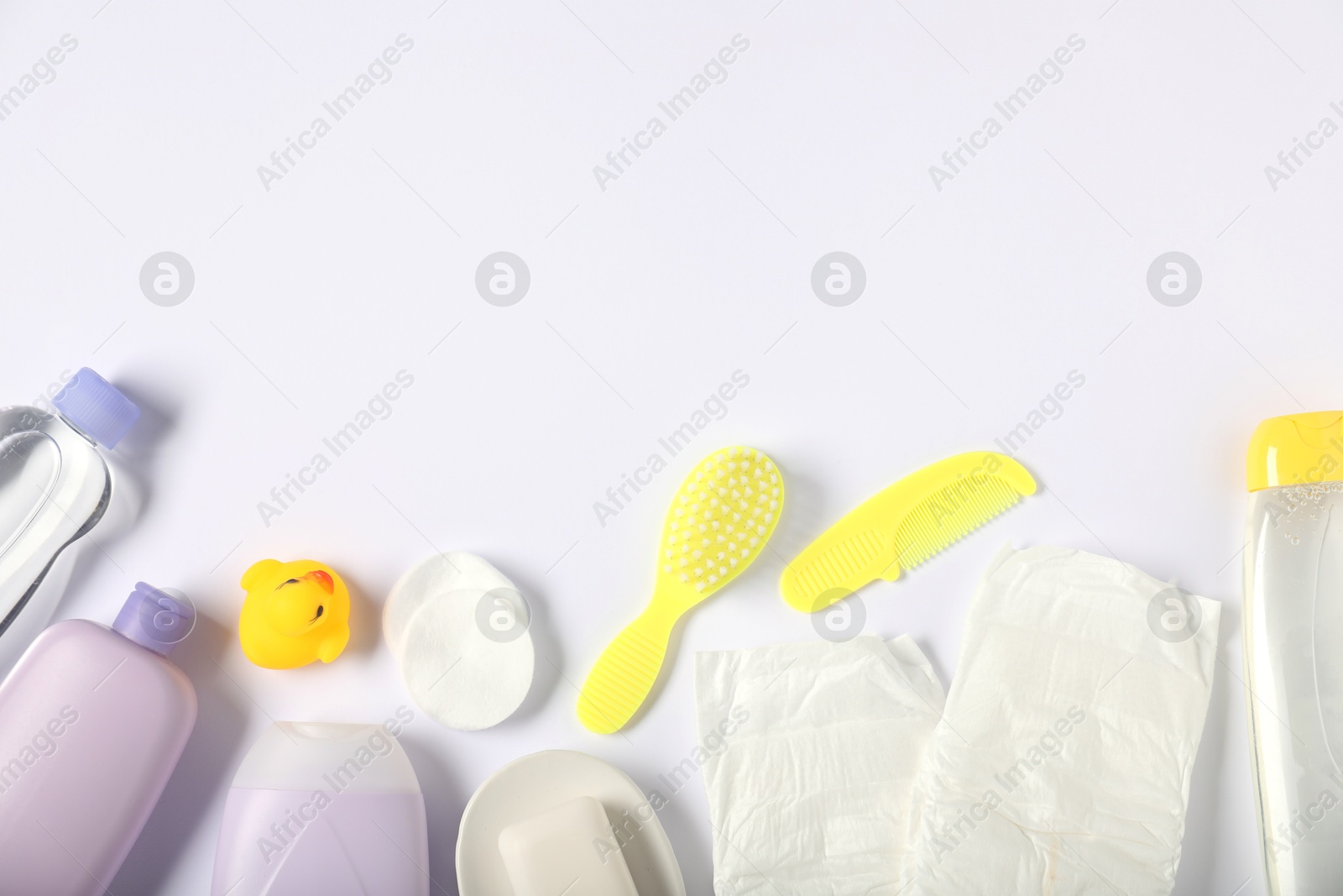 Photo of Baby accessories and cosmetic products on white background, flat lay. Space for text