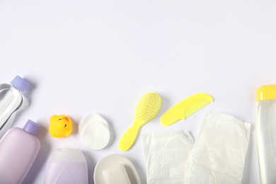 Photo of Baby accessories and cosmetic products on white background, flat lay. Space for text