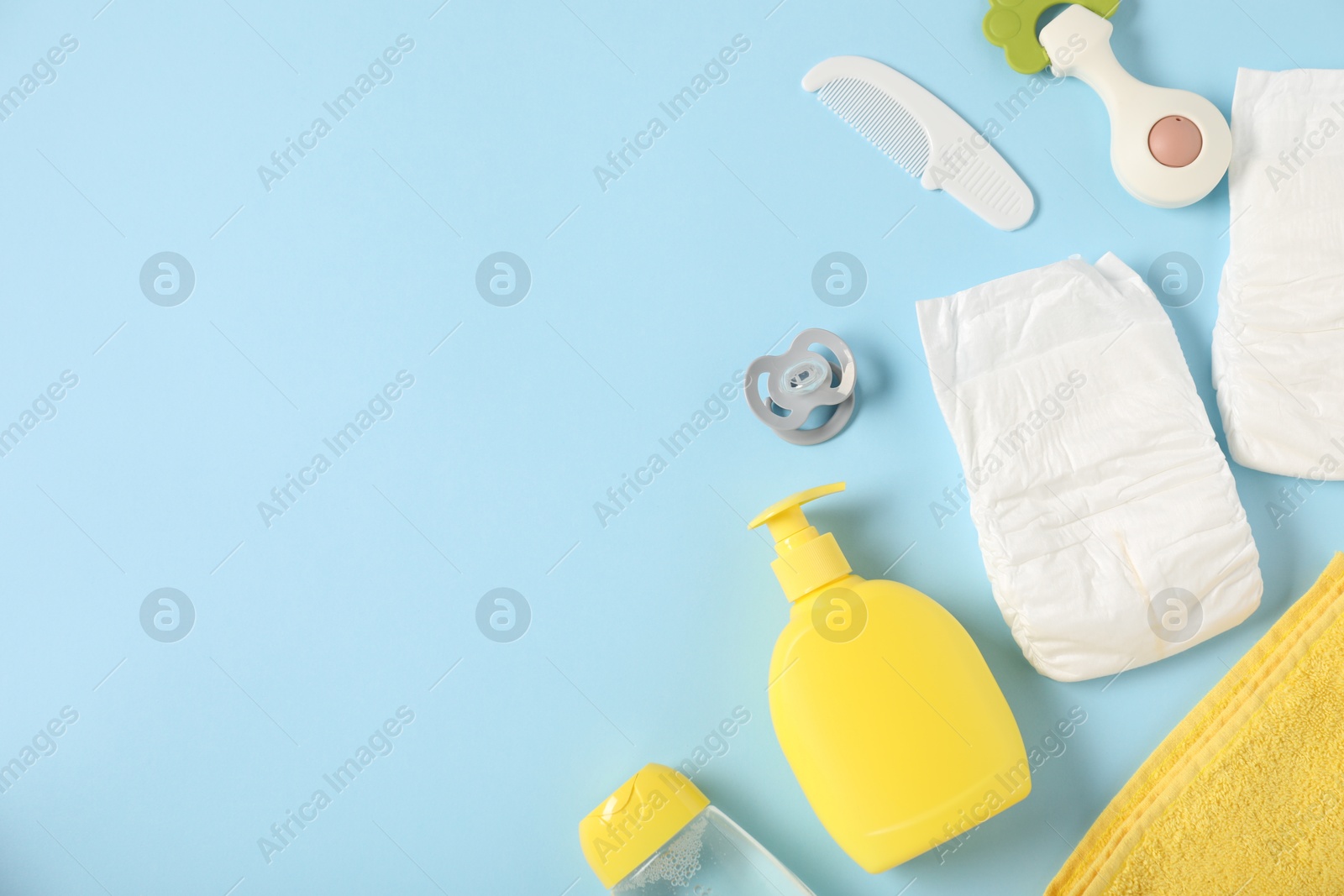 Photo of Baby accessories and cosmetic products on light blue background, flat lay. Space for text