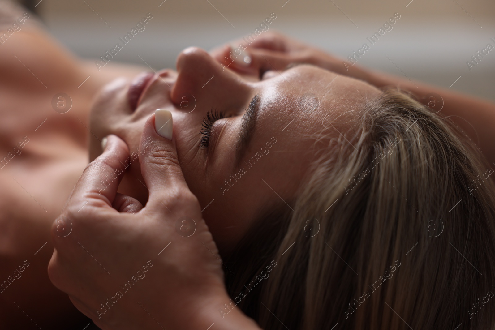 Beautiful woman receiving facial massage, closeup view Photo of Beautiful woman receiving facial massage, closeup view