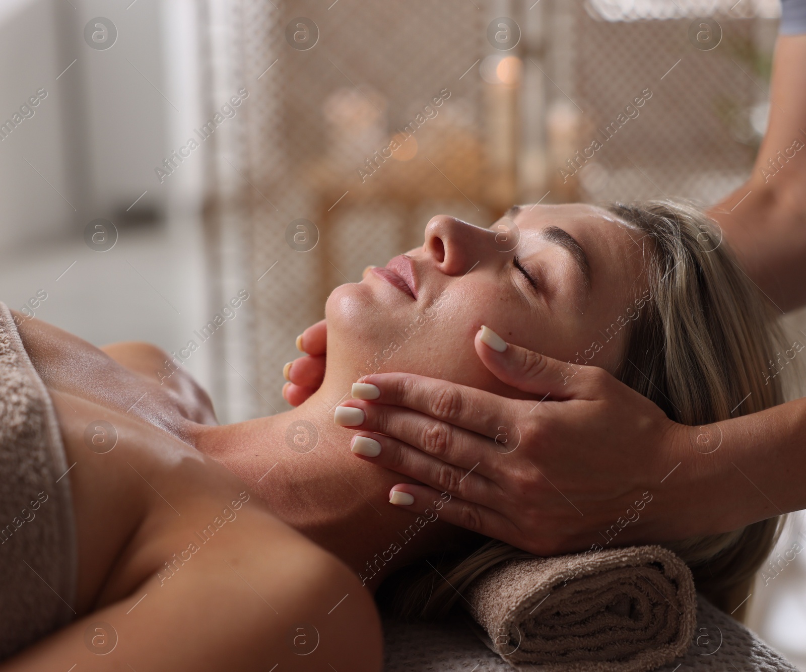 Beautiful woman receiving facial massage in spa salon, closeup Photo of Beautiful woman receiving facial massage in spa salon, closeup