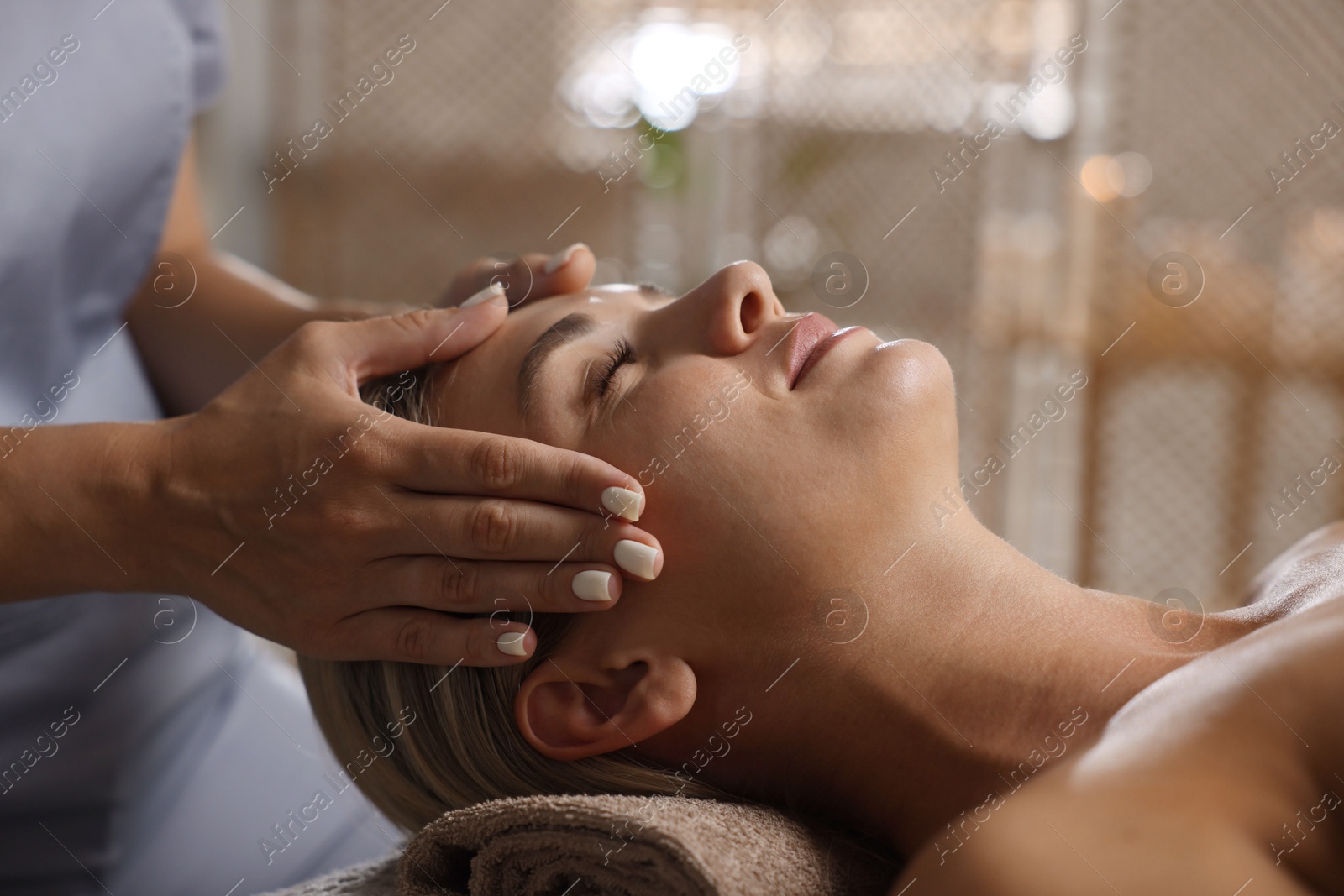 Beautiful woman receiving facial massage in spa salon, closeup Photo of Beautiful woman receiving facial massage in spa salon, closeup