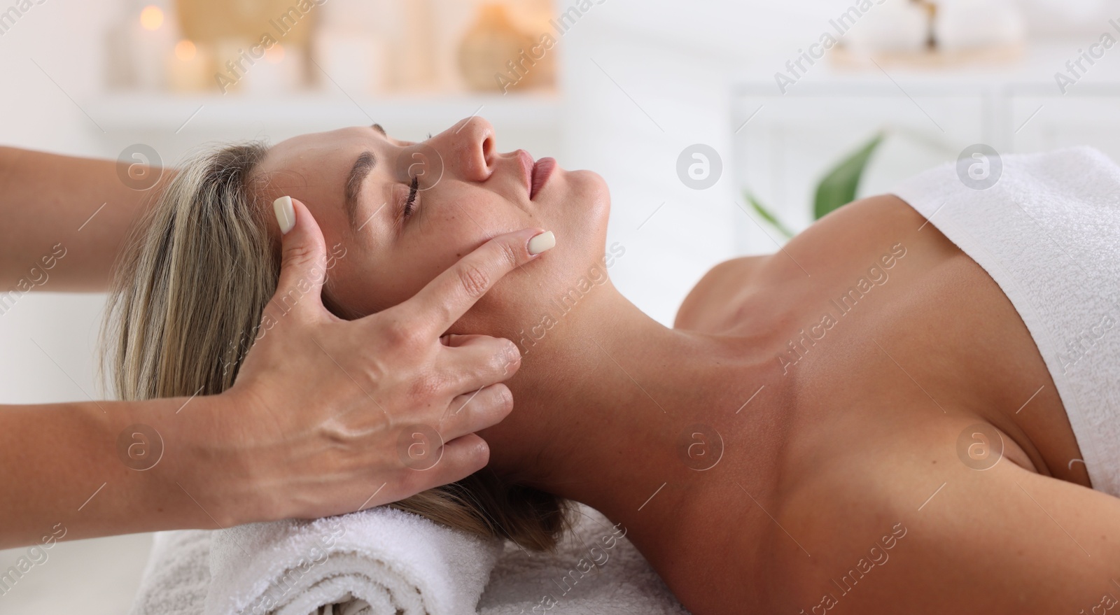 Beautiful woman receiving facial massage in spa salon, closeup Photo of Beautiful woman receiving facial massage in spa salon, closeup