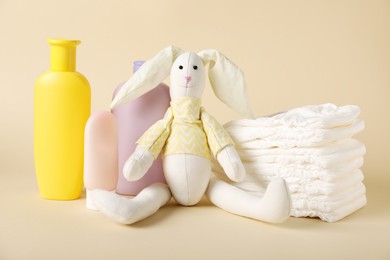 Photo of Baby accessories and cosmetic products on beige background