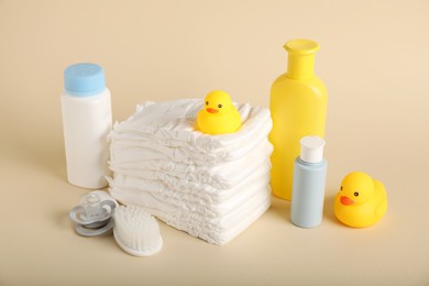 Photo of Baby accessories and cosmetic products on beige background