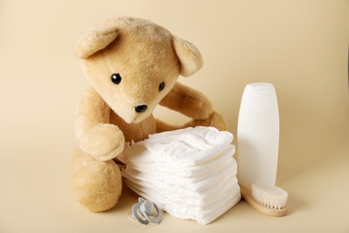 Photo of Baby accessories and cosmetic product on beige background