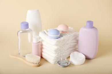 Photo of Baby accessories and cosmetic products on beige background