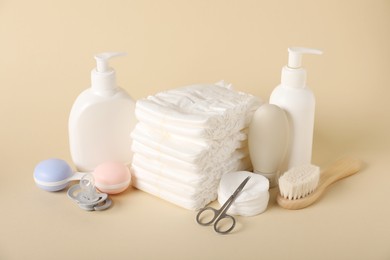 Photo of Baby accessories and cosmetic products on beige background
