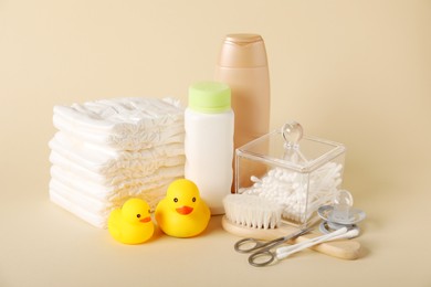 Photo of Baby accessories and cosmetic products on beige background