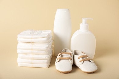Photo of Baby accessories and cosmetic products on beige background