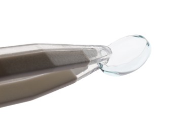 Photo of Tweezers with contact lens isolated on white