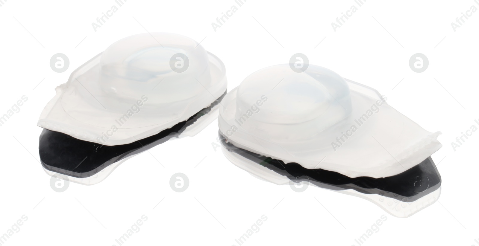 Photo of Blister packs with contact lenses isolated on white