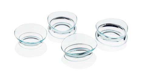 Photo of Many transparent contact lenses isolated on white