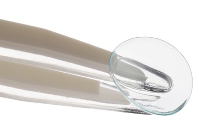 Photo of Tweezers with contact lens isolated on white
