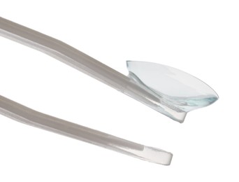 Photo of Tweezers with contact lens isolated on white