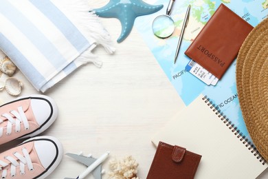 Photo of Time for summer vacation. World map, toy plane, passport, flight tickets, purse, shoes, notebook and beach accessories on light wooden table, flat lay. Space for text