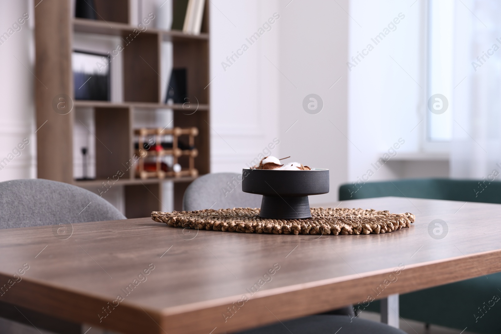 Photo of Wooden table with chairs and decor in dining room, closeup. Interior design