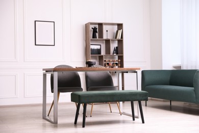 Photo of Wooden table with chairs, bench and decor in dining room. Interior design