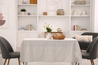 Photo of Stylish table with chairs and decor in dining room. Interior design