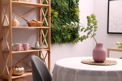Photo of Stylish table with chair and decor in dining room. Interior design