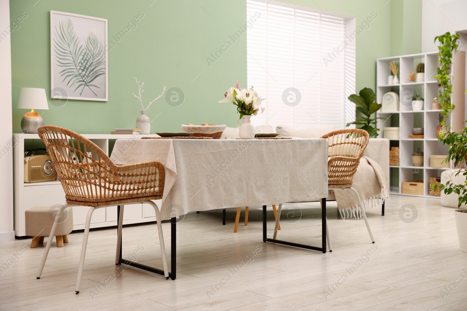 Photo of Stylish table with chairs and decor in dining room. Interior design