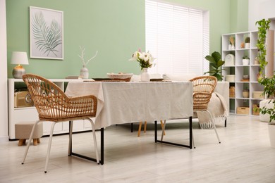 Photo of Stylish table with chairs and decor in dining room. Interior design