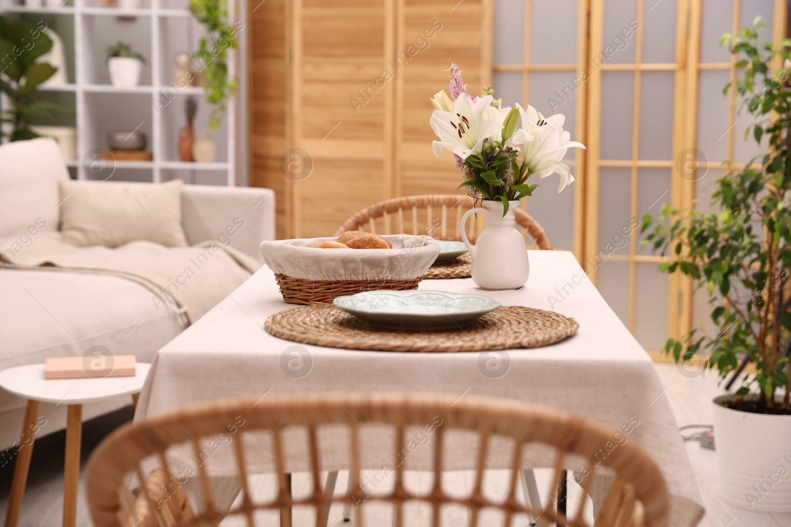 Photo of Stylish table with chairs and decor in dining room. Interior design